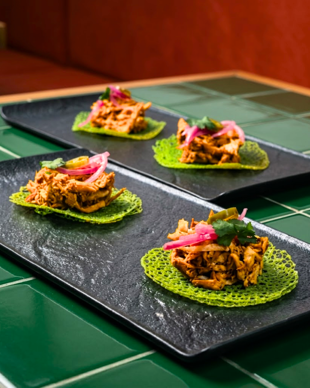 Mezcal tacos served on crisp green tortillas